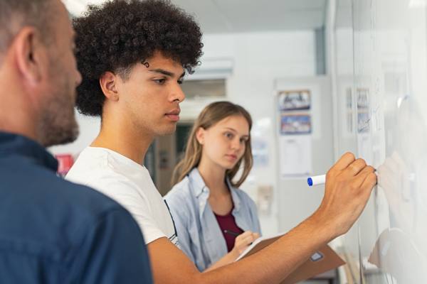 Students and teacher at a whiteboard