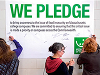 participants signing the Voices of Hunger pledge