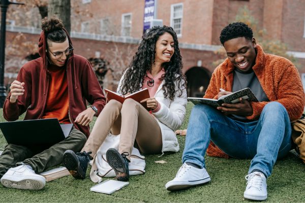 Students sitting outside with notebooks