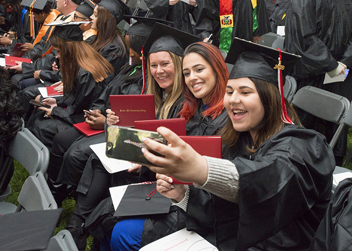 students taking selfies at graduation