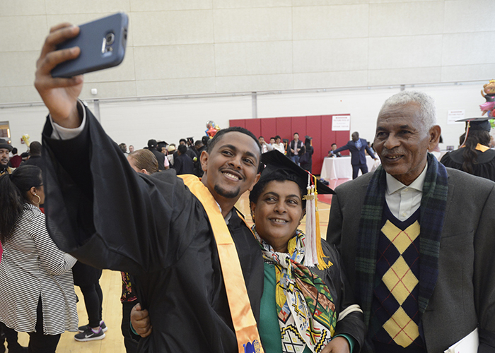 student taking a selfie with his family