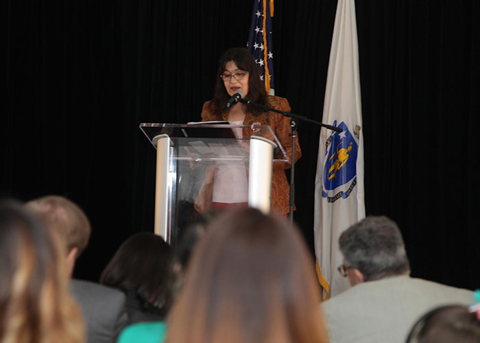 Alice Murillo speaking at the podium