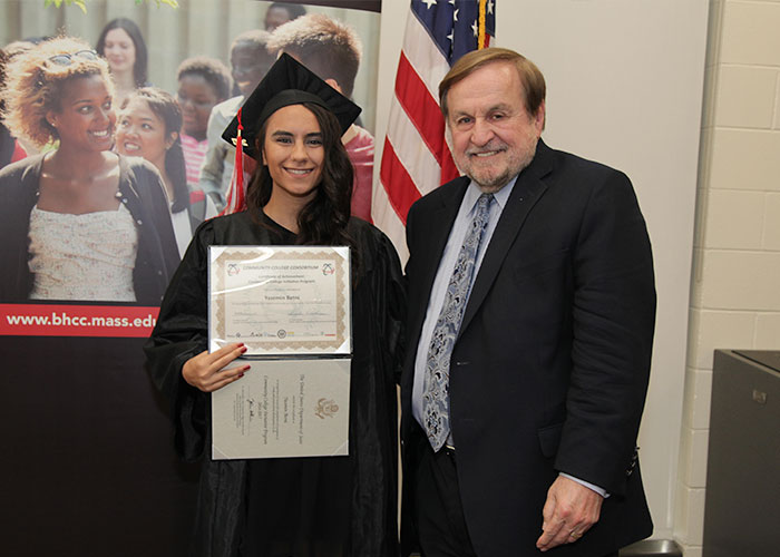female student posing with certificate and dr. canniff