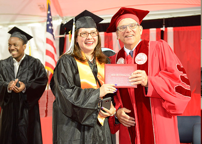 Bill Walczak gives student a diploma