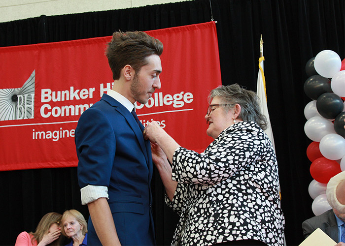 male student receiving his nurse pin