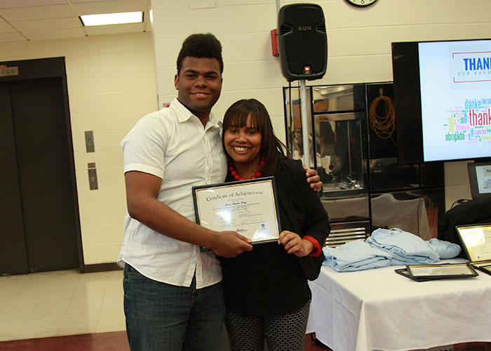 male student posing with certificate with Latoya Robinson