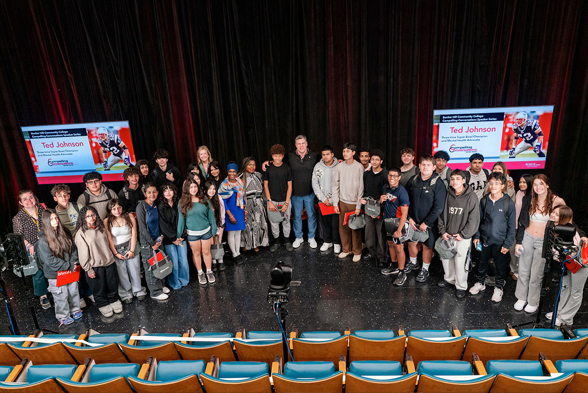 Ted Johnson on stage with students