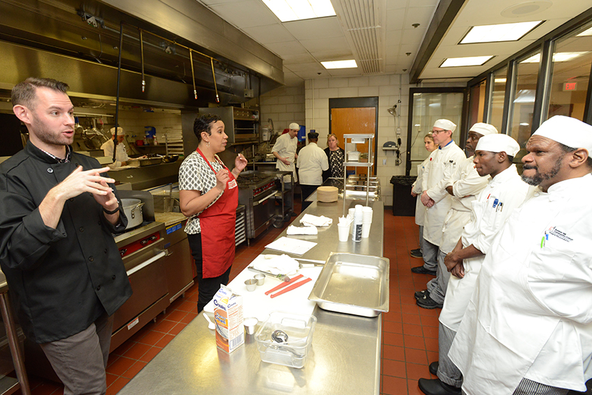 Elle-Simone instructing Culinary art students in the culinary art kitchen