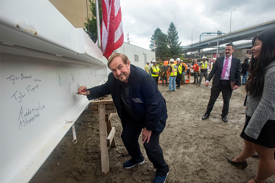 Dr. Canniff signing the beam