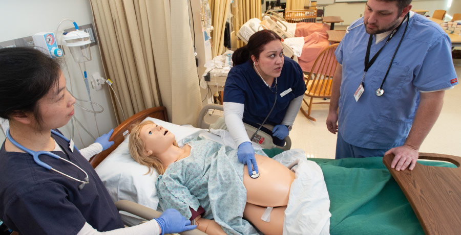 Nursing Article Banner - Students checking for pulse on a  patient manikin