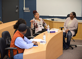 Terry McMillan speaking with BHCC students