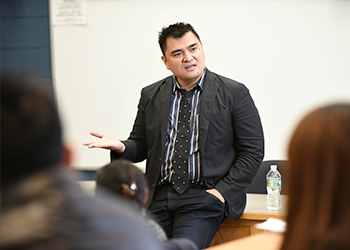 Jose Vargas speaking to students in a classroom