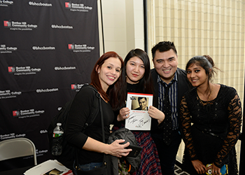 Jose Vargas posing with students during a book signing